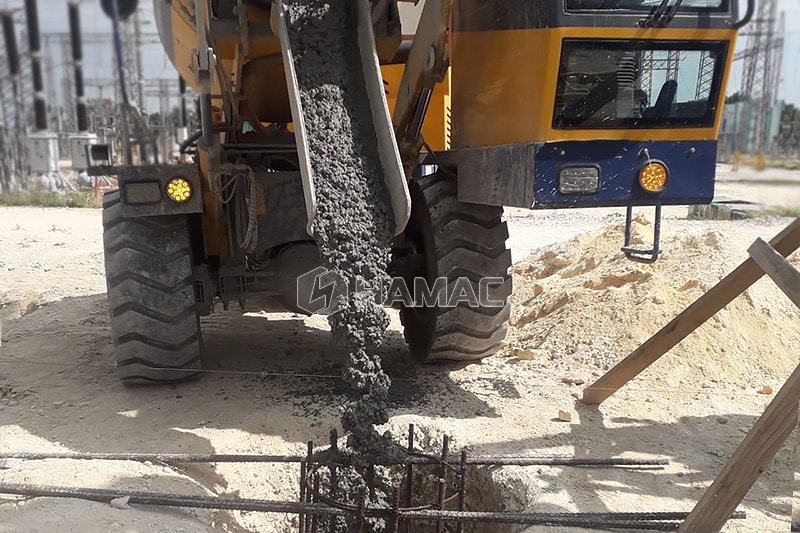 Ready mixed concrete is discharged from this self loading concrete mixer.